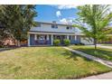 Charming two-story home with a well-manicured lawn and inviting front porch at 6726 S Franklin St, Centennial, CO 80122