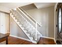 Inviting foyer staircase features wood flooring and white railing at 6726 S Franklin St, Centennial, CO 80122