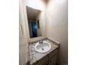 A full sized bathroom, featuring white walls, a large mirror, and modern fixtures at 8826 E Florida Ave # 102, Denver, CO 80247