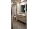 Bathroom featuring a vanity with white cabinets and a shower and tub combination at 8826 E Florida Ave # 102, Denver, CO 80247