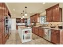 Spacious kitchen with stainless steel appliances, custom cabinets and a marble island counter top at 7631 Oak St, Arvada, CO 80005