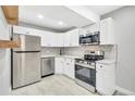 Modern white kitchen with stainless steel appliances at 2707 Valmont Rd # 106B, Boulder, CO 80304