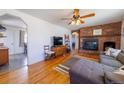Cozy living room with a brick fireplace and hardwood flooring at 3310 W 95Th Ave, Westminster, CO 80031