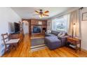 Inviting living room with a brick fireplace, hardwood floors, and a comfortable couch at 3310 W 95Th Ave, Westminster, CO 80031