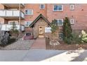 Charming entrance to the Heidelberg Condominiums with a peaked roof and brick walkway at 1270 N Marion St # 505, Denver, CO 80218