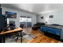 Bright living room featuring hardwood floors, a fireplace, and a sliding glass door to the balcony at 1270 N Marion St # 505, Denver, CO 80218