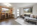 Stylish living room featuring a cozy gray sectional and hardwood floors at 3700 Zenobia St, Denver, CO 80212