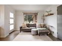 Sunlit living room featuring a comfortable sofa and a large window with neighborhood views at 3700 Zenobia St, Denver, CO 80212