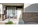 Inviting front porch featuring chairs, perfect for relaxing outdoors with a view at 18006 E 103 Ave, Commerce City, CO 80022