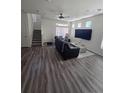Bright living room featuring laminate flooring, large window and comfortable seating arrangements at 18006 E 103 Ave, Commerce City, CO 80022