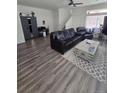Modern living room with sleek laminate flooring, comfortable seating, and a stylish ceiling fan at 18006 E 103 Ave, Commerce City, CO 80022