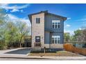 Charming two-story home with gray siding and stone accents, offering a warm and inviting curb appeal at 5470 Krameria St, Commerce City, CO 80022
