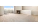 Spacious living room featuring a fireplace and sliding glass doors opening to a balcony at 905 S Zeno Way # 204, Aurora, CO 80017