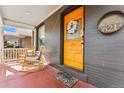 Inviting front porch with rocking chairs, a decorative door, and address plaque, perfect for relaxing outdoors at 621 S Sherman St, Denver, CO 80209