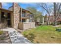Exterior of property showcasing the balcony, chimney, and sidewalk leading up to entrance at 7720 W 87Th Dr # J, Arvada, CO 80005