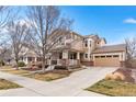 Inviting two-story home featuring a spacious driveway, attached garage, and well-manicured landscaping at 3410 Uinta St, Denver, CO 80238