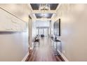 Elegant hallway with hardwood floors, chandelier lighting, neutral paint, and tasteful decor at 268 Simmental Loop, Castle Rock, CO 80104