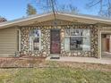 House exterior featuring stone accents and a classic design at 5619 E Minnesota Dr, Denver, CO 80224