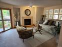 A living room featuring a fireplace, neutral walls, stylish decor and sliding door to outdoor living at 2802 Sundown Ln # 103, Boulder, CO 80303