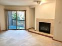 Open living room area with fireplace and sliding glass doors to a private balcony, great for relaxing at 2802 Sundown Ln # 103, Boulder, CO 80303