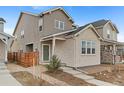 Inviting home exterior with stone accents, landscaped yard, and charming curb appeal at 23820 E 34Th Ave, Aurora, CO 80019