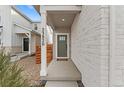 Inviting covered front porch with stylish stone and views of the friendly neighborhood at 23820 E 34Th Ave, Aurora, CO 80019