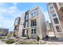 Modern townhome with stone accents, a small balcony, and professionally landscaped front yard at 11918 Mountview Ln, Broomfield, CO 80021