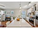 Open kitchen and living area with a large quartz island and stainless steel appliances at 3444 Lawrence St, Denver, CO 80205