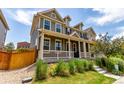Attractive two-story home with a welcoming front porch and well-maintained lawn and garden at 14065 Harrison St, Thornton, CO 80602