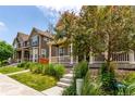 Street view showcasing a row of well-kept homes, each with a front porch and landscaped front yard at 14065 Harrison St, Thornton, CO 80602