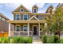 Two-story home with a covered porch, beautiful landscaping, and inviting curb appeal at 14065 Harrison St, Thornton, CO 80602