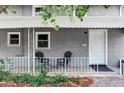 Inviting covered porch with seating and decorative details at 2565 Pierce St, Lakewood, CO 80214