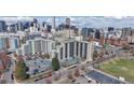 An aerial view of the building with cityscape in the background and ample parking available at 601 W 11Th Ave # 1109, Denver, CO 80204