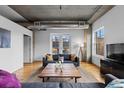 Cozy living room showcasing a balcony view, comfortable seating, and hardwood flooring at 1499 Blake St # 3O, Denver, CO 80202
