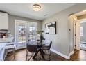 Cozy dining area with a glass table, hardwood floors, and convenient access to outdoor space at 2920 Ivy St, Denver, CO 80207