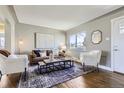 Bright living room with hardwood floors, a neutral color palette, and stylish modern furniture at 2920 Ivy St, Denver, CO 80207