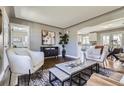 Inviting living room showcasing stylish seating, hardwood floors, and a decorative accent wall at 2920 Ivy St, Denver, CO 80207