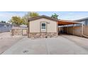 Charming single story home with paved drive, carport and stone accent base at 8426 Cook Way, Denver, CO 80229