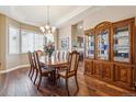Formal dining room featuring hardwood floors, crown molding, and a large window at 6711 S Catawba Way, Aurora, CO 80016