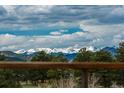 Serene mountain views framed by lush green trees from the property's vantage point at 280 Hess Ave, Golden, CO 80401