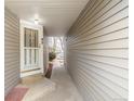 Inviting entrance with a white security door and well lit entry way at 93 S Nome St, Aurora, CO 80012