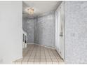 Bright foyer with tile flooring and a staircase, showcasing neutral wall tones at 93 S Nome St, Aurora, CO 80012