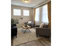 Cozy living room with an elegant rug, modern furnishings, and bright natural light at 23895 E Rocky Top Pl, Aurora, CO 80016