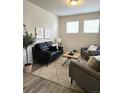 Bright living room featuring modern decor, stylish furnishings, and ample natural light at 23895 E Rocky Top Pl, Aurora, CO 80016