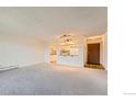 Empty living room featuring an open view to the kitchen area, and natural light at 14152 E Linvale Pl # 509, Aurora, CO 80014