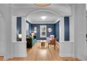 Inviting living room with blue accent wall, white trim, hardwood floors, and ample natural light at 3212 Fulton St, Denver, CO 80238