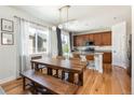 Bright kitchen with wood floors, a dining area, and lots of natural light at 3567 E 140Th Dr, Thornton, CO 80602