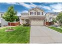 Charming two-story home with a brick facade, manicured lawn, and inviting curb appeal at 10245 Nottingham Dr, Parker, CO 80134