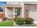 Inviting front porch with rocking chairs, lush landscaping, and an American flag at 10245 Nottingham Dr, Parker, CO 80134