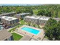 Aerial view showcases the community pool, well-kept grounds, and townhouse exteriors at 1517 S Owens St # 5, Denver, CO 80232